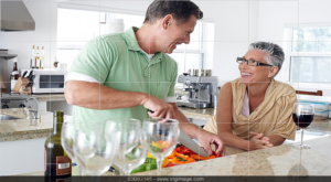 An older couple making dinner together at home