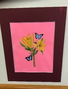 A painting of flowers and butterflies hung on a wall