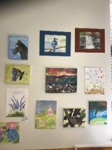 A group of paintings hanging on a wall