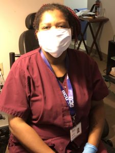A woman wearing a white protective face mask