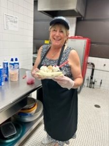 A volunteer makes a banana split