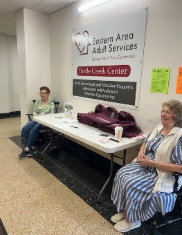 two women volunteering as greeters at the open house