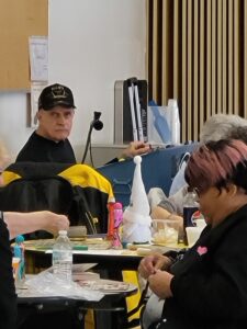 Older adults at a table, playing bingo