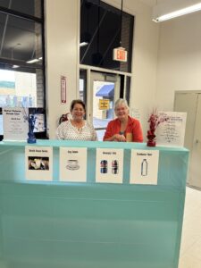 Volunteers behind the reception desk in the lobby