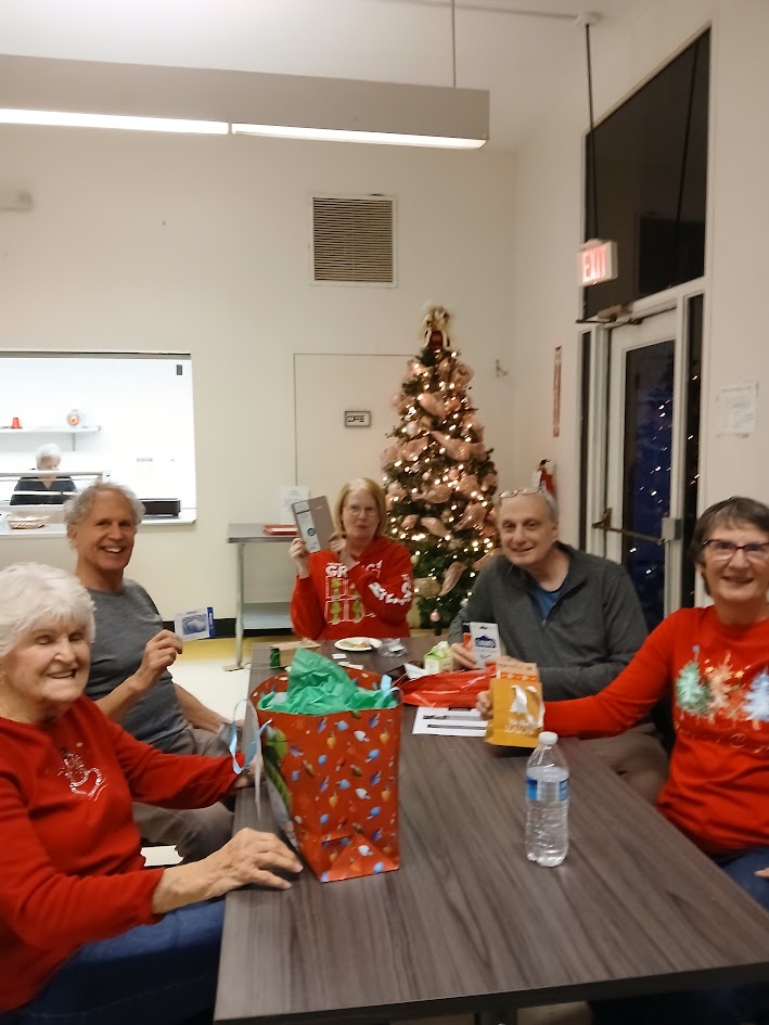 Smiling seniors sitting around a table
